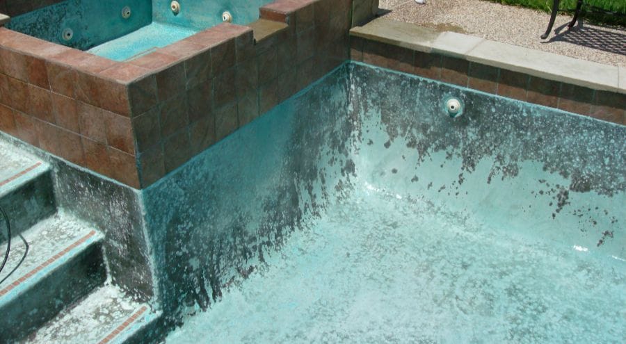 The Inside Of An Empty In-Ground Pool That Needs An Acid Wash Treatment.