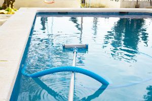 A Pair Of Cleaning Tools Floating In A Pool.