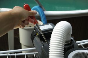 Someone Repairing Pool Equipment In An Emergency.